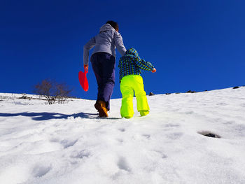 Full length rear view of women in winter