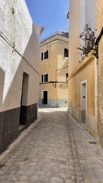 Footpath amidst buildings in city