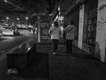 People walking on zebra crossing in city