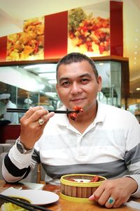 Portrait of man having food at restaurant