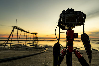 Camera on the beach at sunset