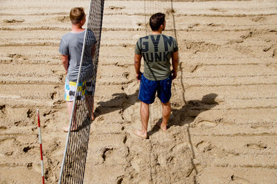 Men playing volleyball at beach