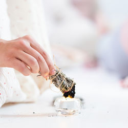 Midsection of woman holding wedding rings