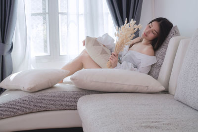 Woman resting on sofa at home