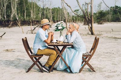 Couple at date against bare trees