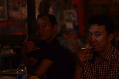 Portrait of young man smoking at restaurant