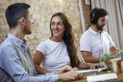 Businesswoman talking with his work mate in the co-working. self confident