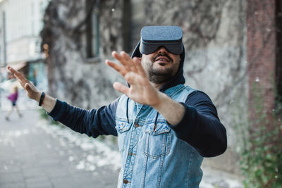 Man wearing virtual reality simulator with cottonwood fluff in mid-air