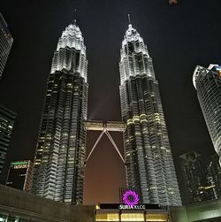 Low angle view of illuminated buildings against sky at night