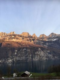 Scenic view of lake and mountains against sky