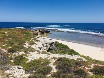 Scenic view of sea against clear blue sky