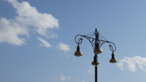 Low angle view of lamp post against blue sky