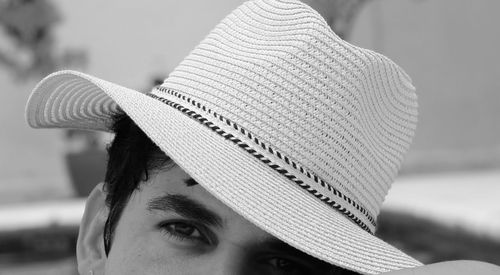 Close-up portrait of mid adult man wearing hat outdoors