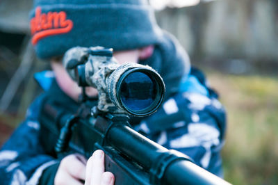 Midsection of man holding camera