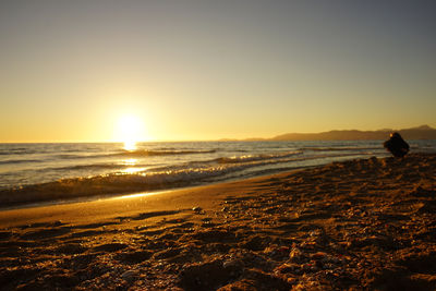 Scenic view of beach against sky during sunset