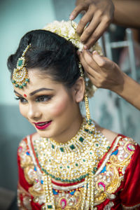 Smiling young woman getting dressed