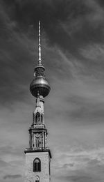 Low angle view of communications tower against sky