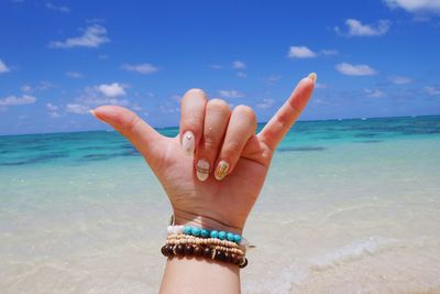 Close-up of woman hand on beach