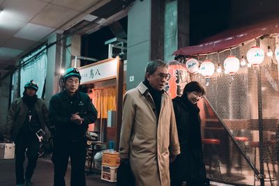 Group of people standing at night