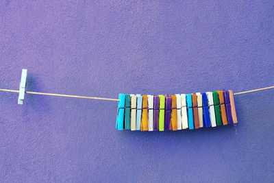 Close-up of multi colored clothespins on clothesline