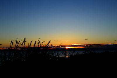 View of lake against clear sky during sunset