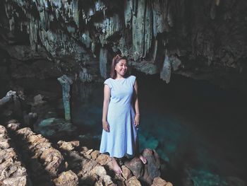 Portrait of woman standing on rock