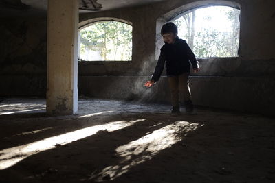 Side view of man standing in corridor