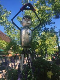 Low angle view of statue in park against sky