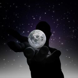 Low angle view of silhouette person against sky at night