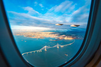 Aerial view suspension bridge seen through airplane