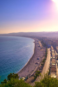 High angle view of city by sea against sky