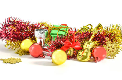 Close-up of christmas decorations over white background