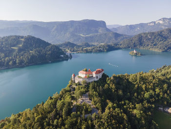 Aerial view of blejski grad, a beautiful castle built on top of a rock facing lake bled 