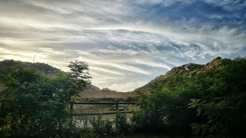 Scenic view of lake against cloudy sky