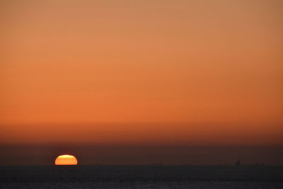 Scenic view of sea against orange sky