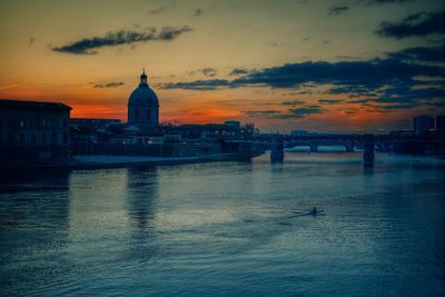 View of bridge over river against cloudy sky