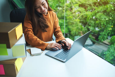 Young woman using laptop on table