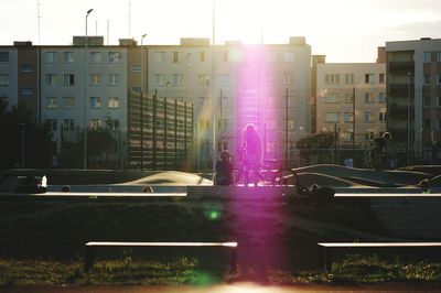 Buildings in city against sky during sunset