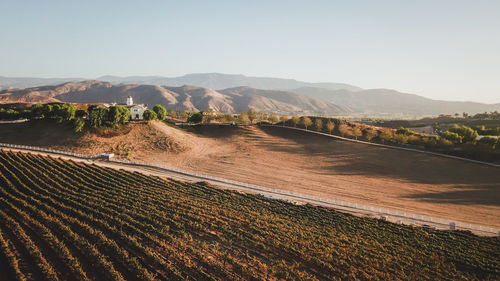 Scenic view of landscape and mountains against clear sky