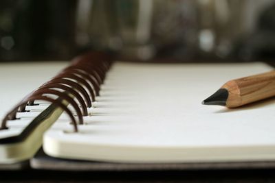 Close-up of book and pencil on table