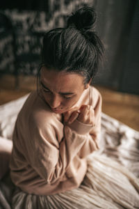 Portrait of a young woman sitting at home