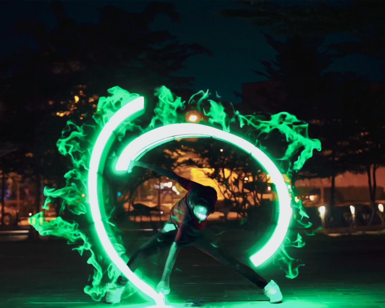 BLURRED MOTION OF MAN WITH ILLUMINATED FERRIS WHEEL