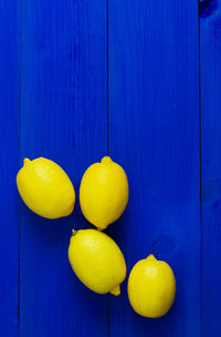 High angle view of lemons on blue wooden table