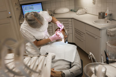 Dentist examining patients teeth