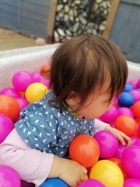 High angle view of cute girl with balloons