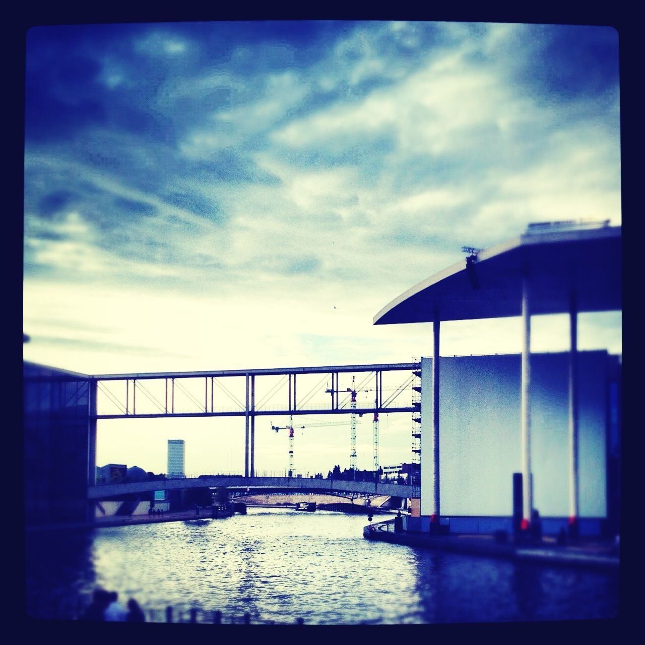 architecture, sky, built structure, water, transfer print, cloud - sky, building exterior, auto post production filter, waterfront, cloud, cloudy, sea, railing, river, city, reflection, bridge - man made structure, nature, bridge, day