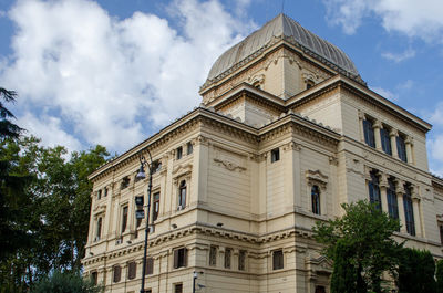 Low angle view of building against cloudy sky