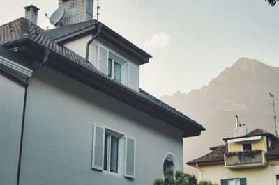 Low angle view of buildings in town against sky