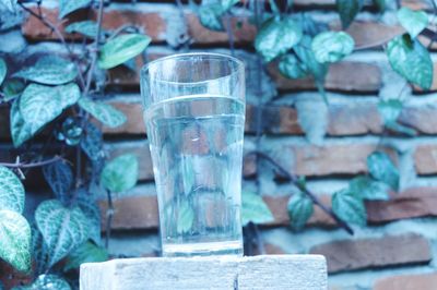 Close-up of drink on table against wall