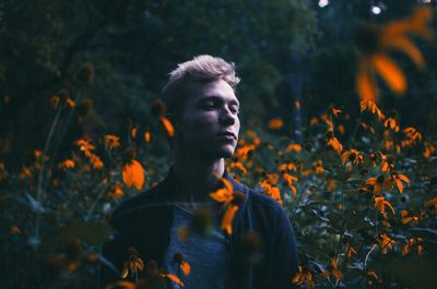 Portrait of young man against plants